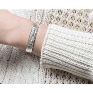 woman wearing wyatt cuff with champagne diamonds and "gratitude" engraved on her sterling silver bracelet