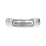 Engraveable sterling silver cuff bracelet with champagne diamond border around engraved "Gratitude" in gothic letters